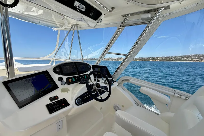 Slide: The Image of Helm of 2003 Riviera 40 Flybridge yacht with ocean view and navigation equipment. - 67