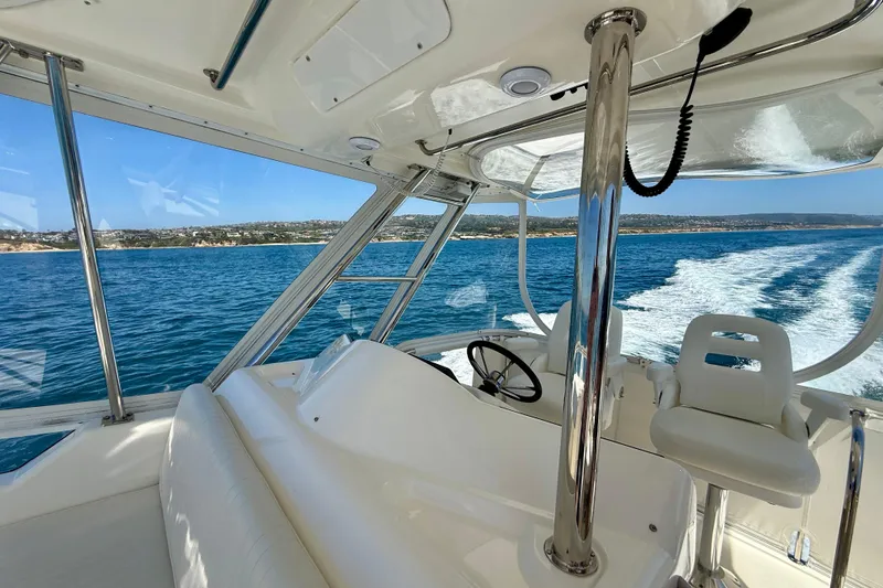 Slide: The Image of 2003 Riviera 40 Flybridge cruising on blue ocean with scenic coastal view. - 69