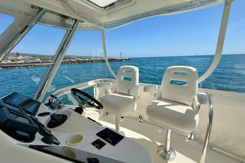 Slide: The Image of Flybridge view of 2003 Riviera 40, showcasing helm and ocean backdrop. - 71