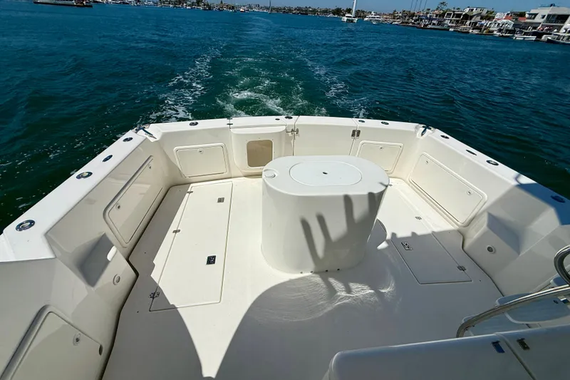 Slide: The Image of Spacious deck of 2003 Riviera 40 Flybridge yacht cruising on open water. - 76