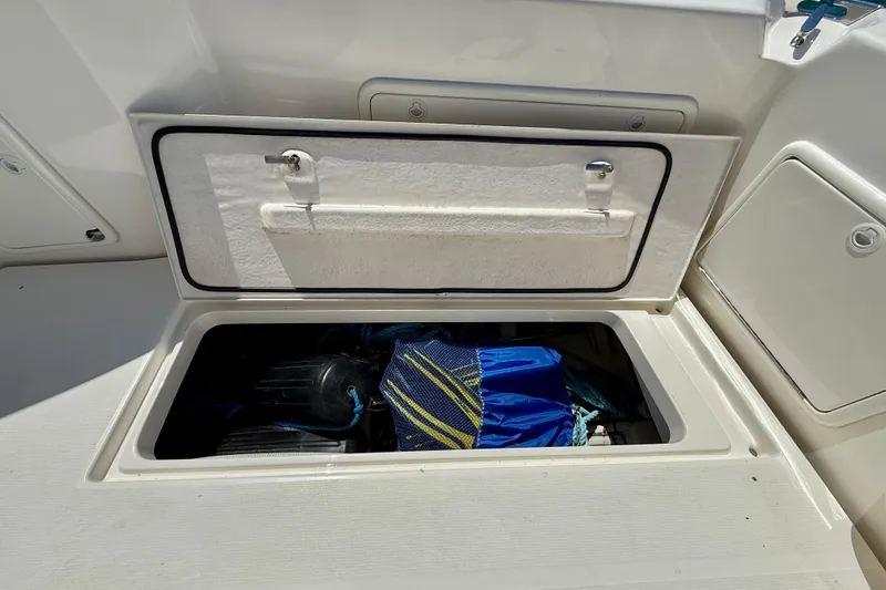 Slide: The Image of Storage compartment on a 2003 Riviera 40 Flybridge boat, containing boating gear. - 77