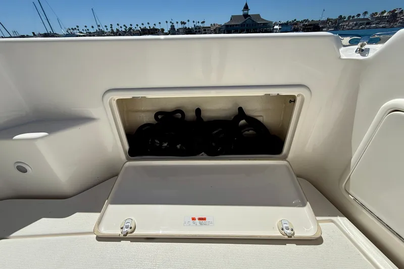 Slide: The Image of Storage compartment on a 2003 Riviera 40 Flybridge boat, open with ropes inside. - 78