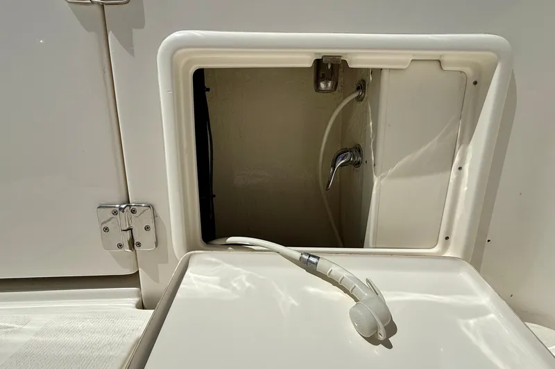 Slide: The Image of 2003 Riviera 40 Flybridge boat shower compartment with hose and faucet. - 79