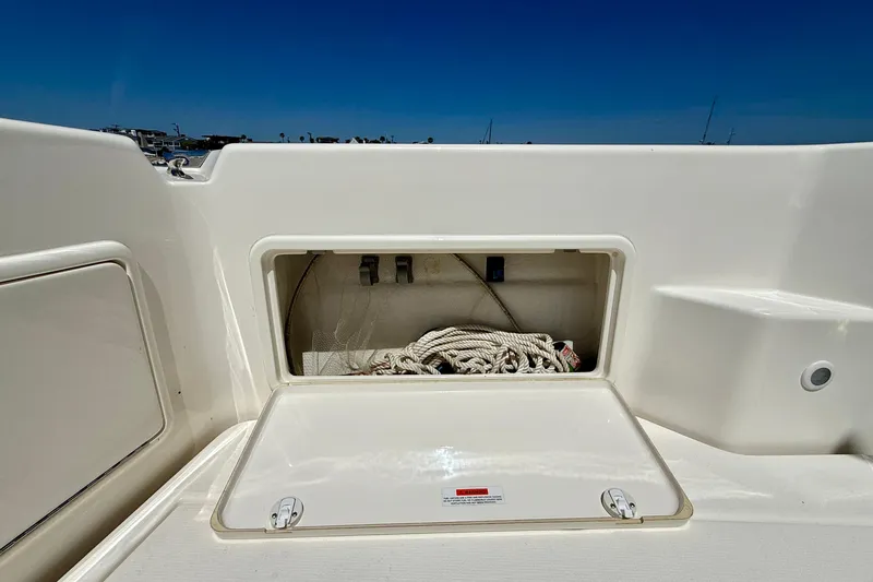 Slide: The Image of Storage compartment on a 2003 Riviera 40 Flybridge boat, containing coiled rope. - 80