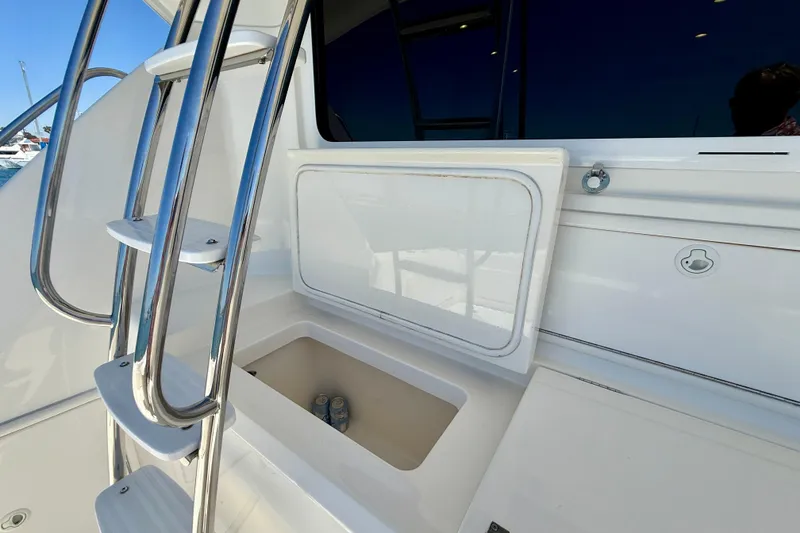 Slide: The Image of Stainless steel ladder and storage compartment on 2003 Riviera 40 Flybridge yacht. - 81