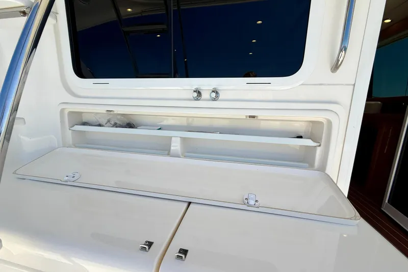 Slide: The Image of 2003 Riviera 40 Flybridge yacht interior storage compartment with open hatch and sleek design. - 83