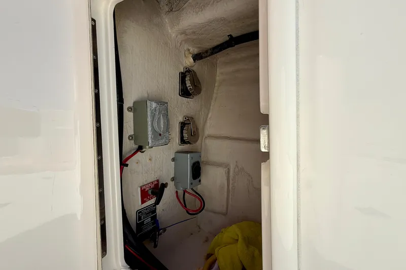 Slide: The Image of Electrical compartment of 2003 Riviera 40 Flybridge boat, featuring wiring and control boxes. - 85
