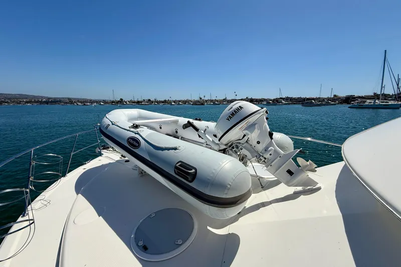 Slide: The Image of 2003 Riviera 40 Flybridge yacht with inflatable boat and Yamaha motor on deck. - 86