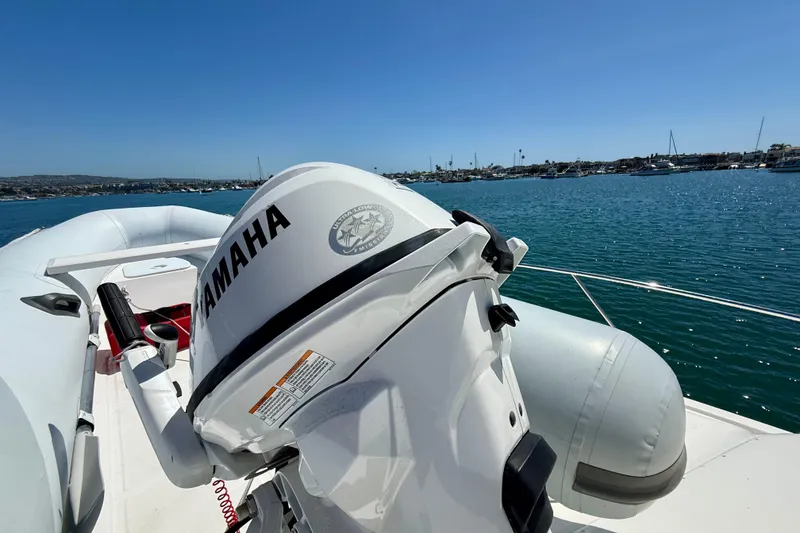 Slide: The Image of 2003 Riviera 40 Flybridge with Yamaha motor on calm waters, scenic harbor view. - 87