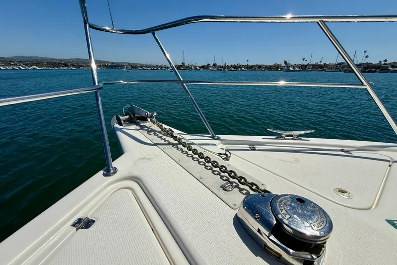 Slide: The Image of Bow of 2003 Riviera 40 Flybridge yacht with anchor chain, overlooking calm waters. - 88