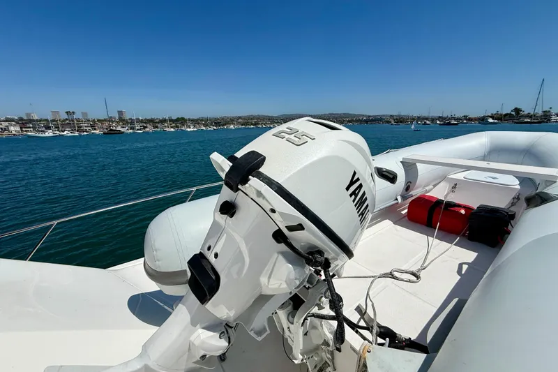 Slide: The Image of 2003 Riviera 40 Flybridge yacht with Yamaha outboard motor on deck, overlooking marina. - 89