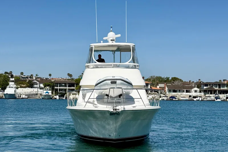 Slide: The Image of Front view of a 2003 Riviera 40 Flybridge yacht on calm water. - 9