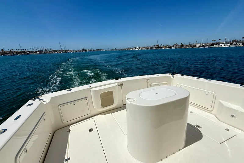 Slide: The Image of 2003 Riviera 40 Flybridge boat cruising on a sunny day, with a clear view of the water. - 90