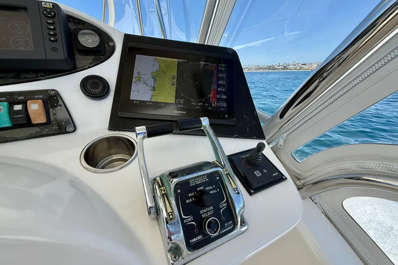 Slide: The Image of Helm of 2003 Riviera 40 Flybridge with navigation display and controls, overlooking the ocean. - 91
