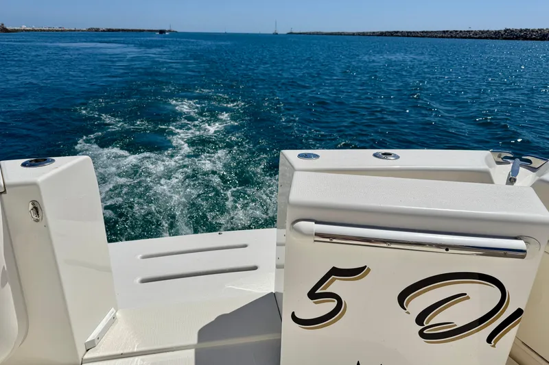 Slide: The Image of 2003 Riviera 40 Flybridge cruising on open water, leaving a wake behind. - 92