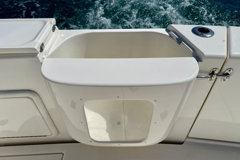 Slide: The Image of Riviera 40 Flybridge 2003 boat deck with open storage compartment and ocean view. - 93