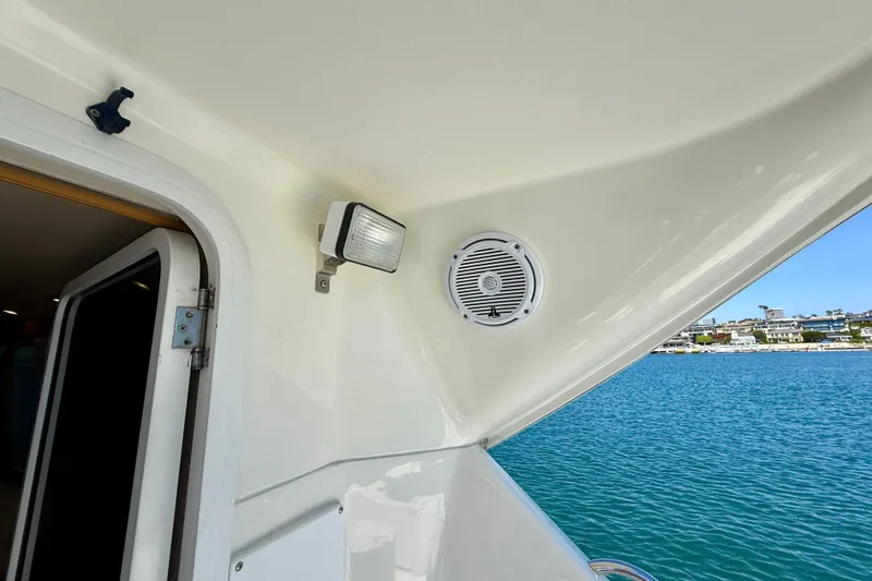 Slide: The Image of 2003 Riviera 40 Flybridge yacht interior with speaker and light, overlooking blue water. - 95