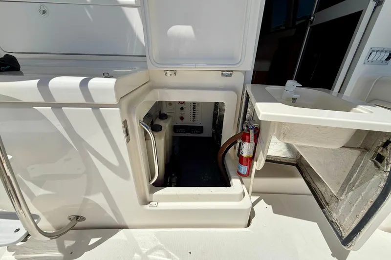 Slide: The Image of 2003 Riviera 40 Flybridge yacht interior with open hatch and fire extinguisher. - 96