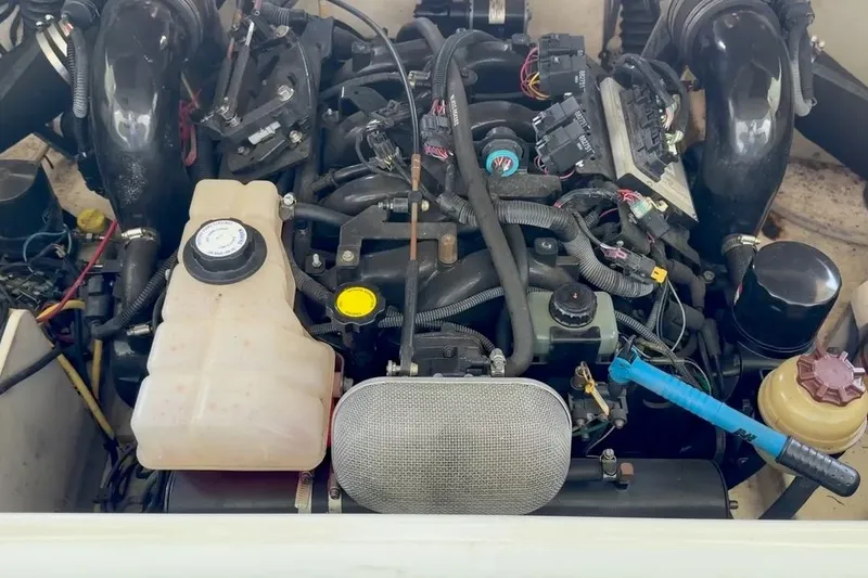 Slide: The Image of Engine compartment of a 2005 Chaparral 256 SSi boat, showcasing various components and wiring. - 13