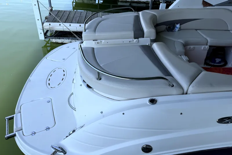 Slide: The Image of 2005 Chaparral 256 SSi boat with sleek seating and swim platform near dock. - 14