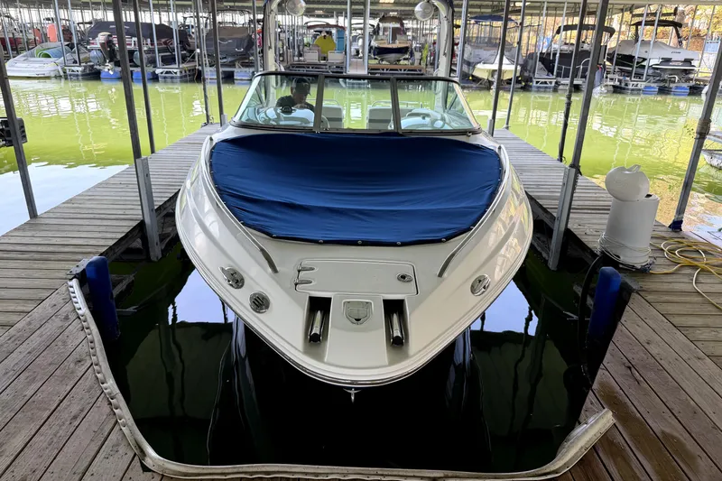 Slide: The Image of 2005 Chaparral 256 SSi boat docked with blue cover in marina. - 3