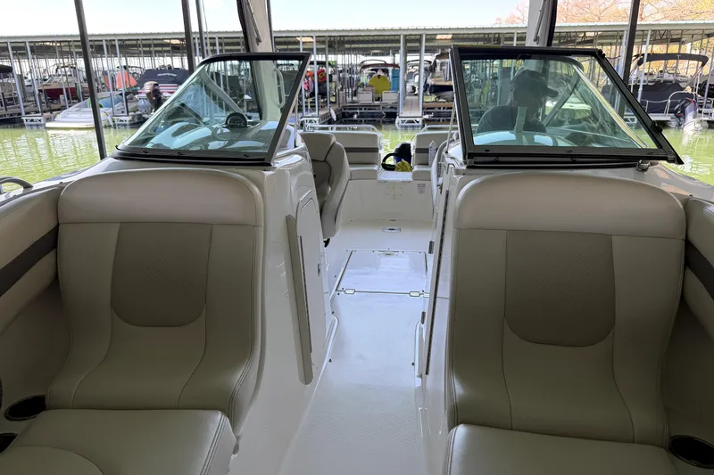 Slide: The Image of Interior view of a 2005 Chaparral 256 SSi boat with beige seating and windshield. - 8