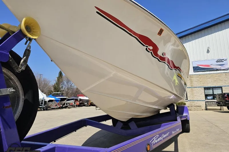 Slide: The Image of 2001 Powerquest 280 Silencer boat on trailer, vibrant graphics, outdoor setting. - 14