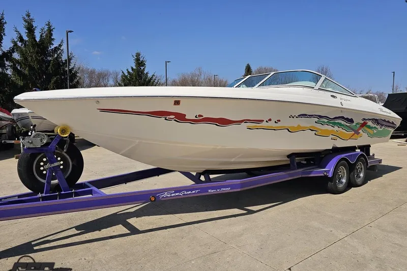 Slide: The Image of 2001 Powerquest 280 Silencer boat on a purple trailer, featuring colorful graphics. - 16