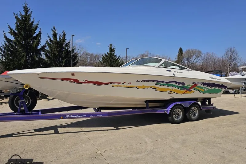 Slide: The Image of 2001 Powerquest 280 Silencer boat on a trailer, featuring colorful graphics. - 17
