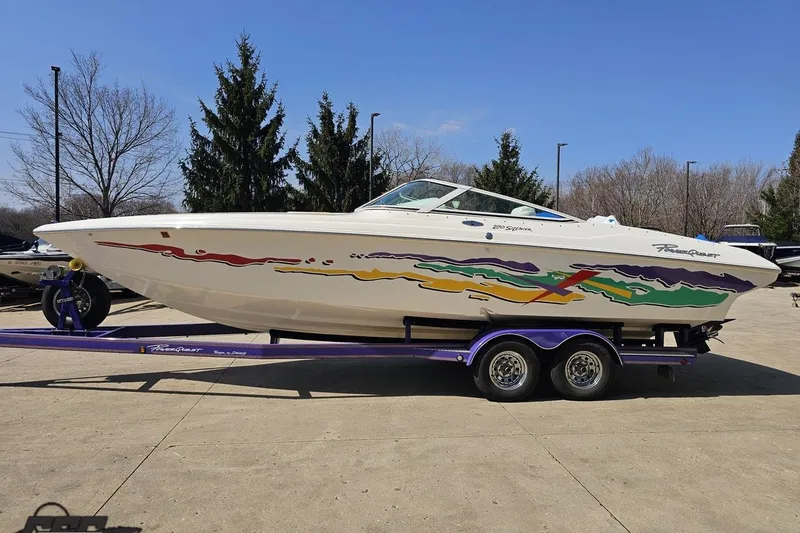 Slide: The Image of 2001 Powerquest 280 Silencer boat on a trailer, featuring colorful graphics and sleek design. - 18