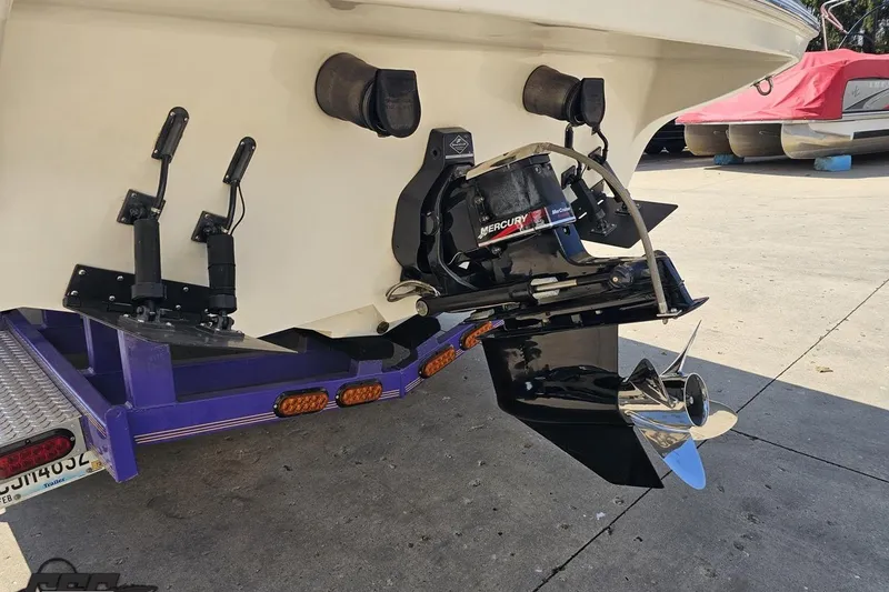 Slide: The Image of Rear view of a 2001 Powerquest 280 Silencer boat with Mercury outboard motor. - 24