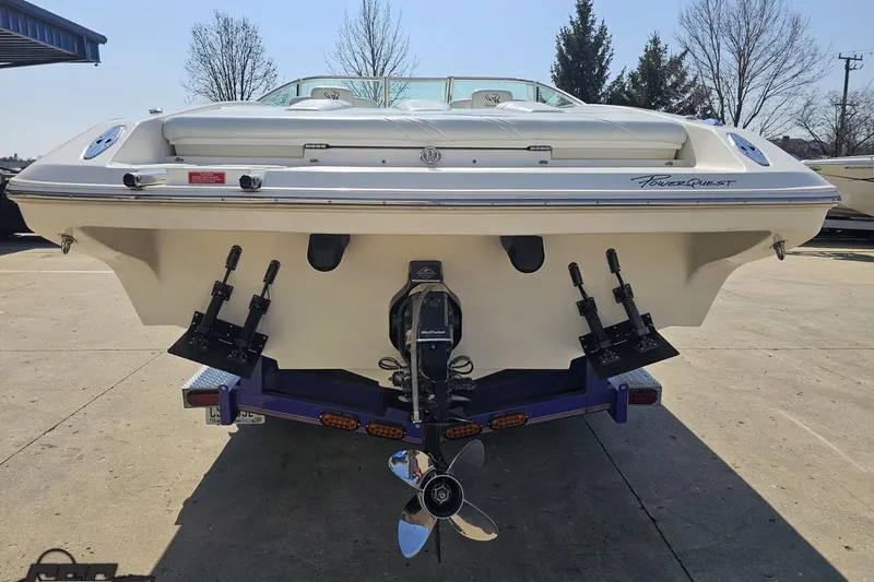 Slide: The Image of 2001 Powerquest 280 Silencer boat, rear view with propeller and trim tabs. - 25