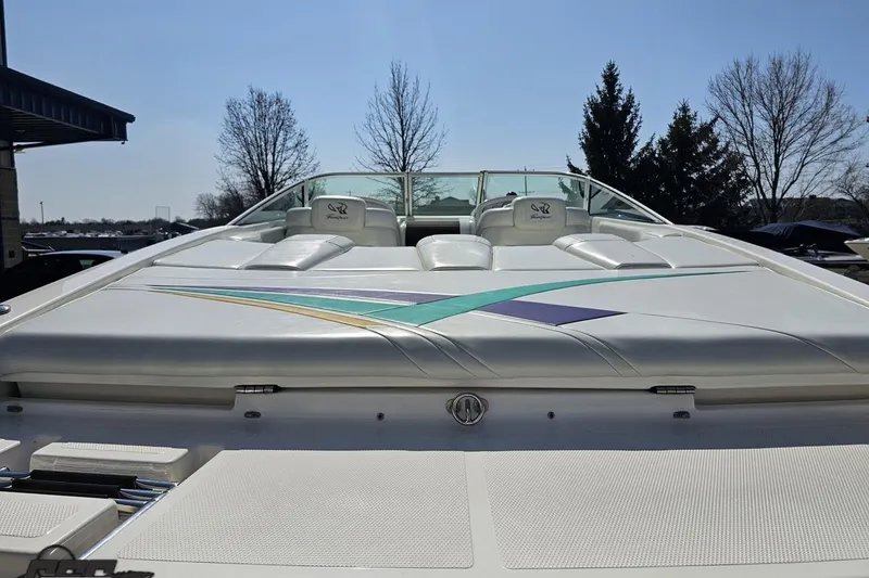 Slide: The Image of 2001 Powerquest 280 Silencer boat with sleek design and colorful accents. - 26