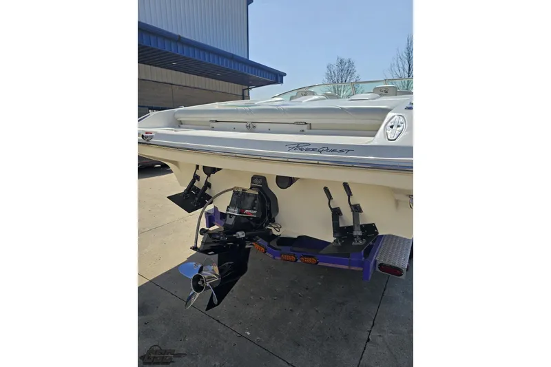 Slide: The Image of Rear view of a 2001 Powerquest 280 Silencer boat with visible outboard motor. - 28