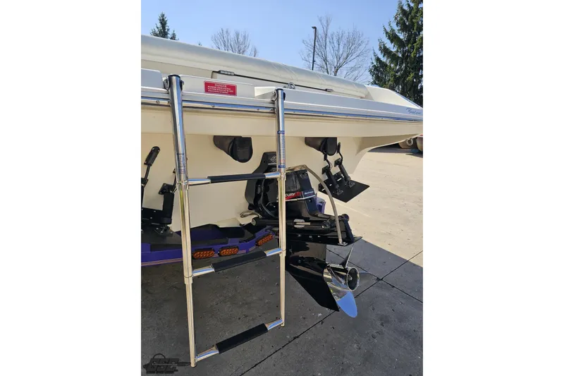 Slide: The Image of 2001 Powerquest 280 Silencer boat stern with ladder and propeller in sunlight. - 29