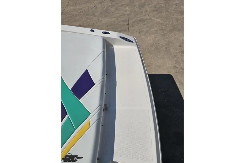 Slide: The Image of 2001 Powerquest 280 Silencer boat with colorful geometric upholstery design. - 30