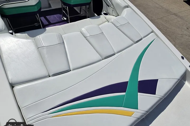 Slide: The Image of 2001 Powerquest 280 Silencer boat interior with white, teal, and purple upholstery design. - 31