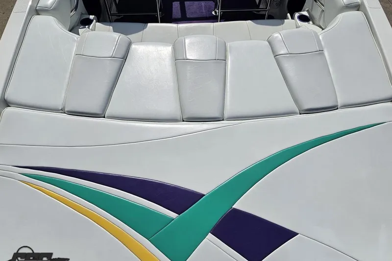 Slide: The Image of 2001 Powerquest 280 Silencer boat interior with white, teal, and purple upholstery design. - 32