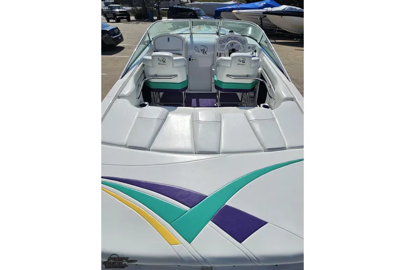 Slide: The Image of 2001 Powerquest 280 Silencer boat interior with colorful upholstery and dual seating. - 33