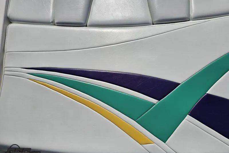 Slide: The Image of Upholstery design on 2001 Powerquest 280 Silencer boat seat with colorful stripes. - 34