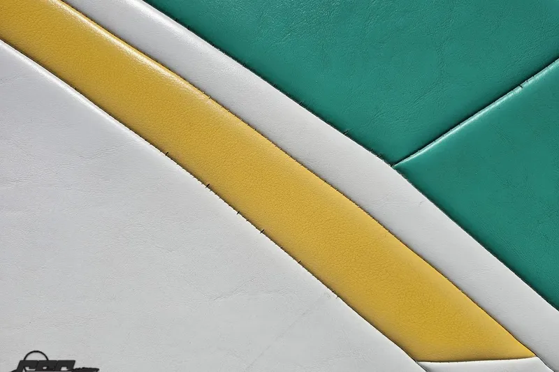 Slide: The Image of Close-up of 2001 Powerquest 280 Silencer upholstery with green, yellow, and white leather design. - 36