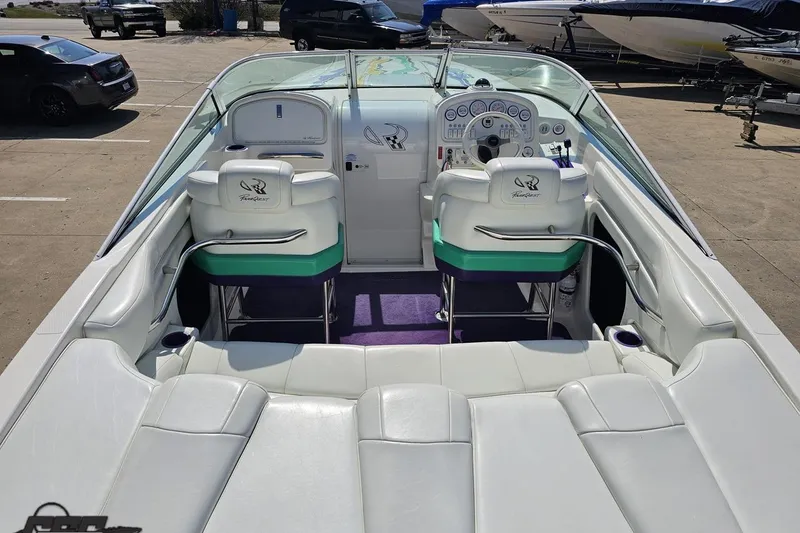 Slide: The Image of 2001 Powerquest 280 Silencer boat interior with white seating and dashboard controls. - 37