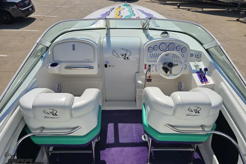 Slide: The Image of Interior of a 2001 Powerquest 280 Silencer boat with white seating and dashboard. - 39