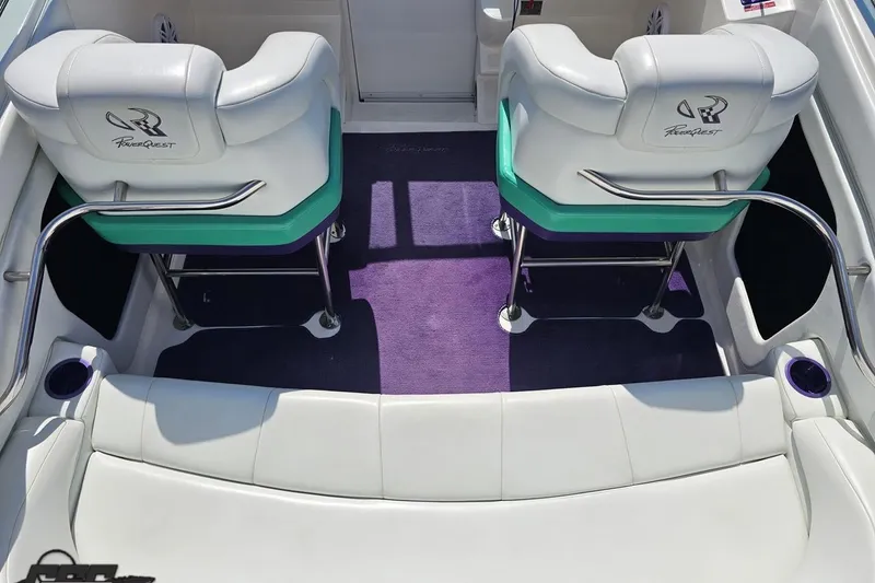 Slide: The Image of Interior of a 2001 Powerquest 280 Silencer boat with white and green seating. - 40