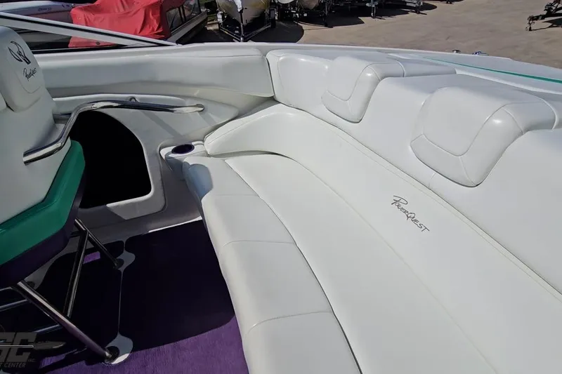 Slide: The Image of Interior of 2001 Powerquest 280 Silencer boat with white seating and purple carpet. - 41