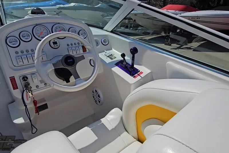 Slide: The Image of Interior view of a 2001 Powerquest 280 Silencer boat cockpit with steering wheel and controls. - 43