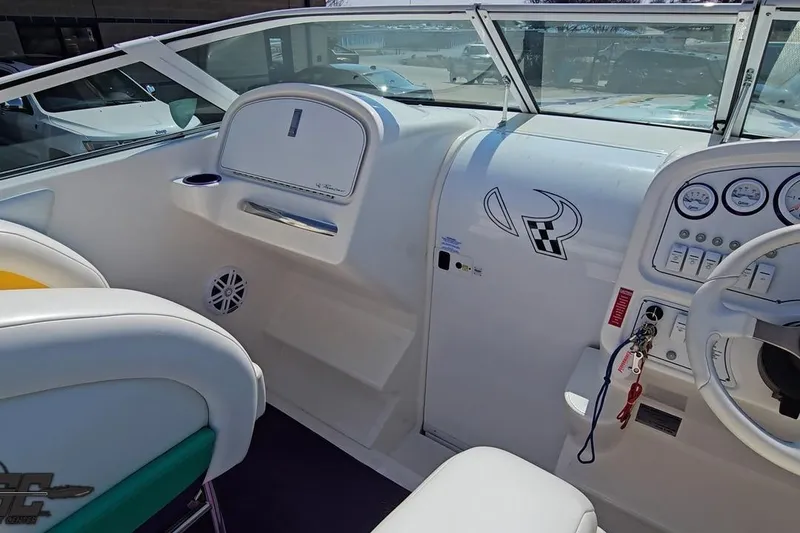 Slide: The Image of Interior of a 2001 Powerquest 280 Silencer boat, featuring dashboard and seating. - 45
