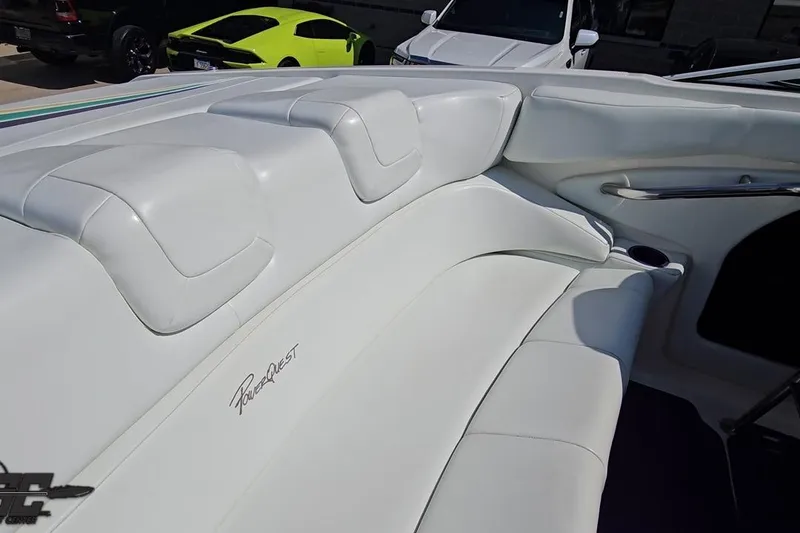 Slide: The Image of 2001 Powerquest 280 Silencer boat interior with white leather seating and logo. - 46