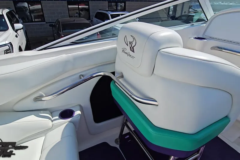 Slide: The Image of Interior of 2001 Powerquest 280 Silencer boat with white seating and logo. - 47