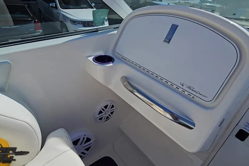 Slide: The Image of Interior of 2001 Powerquest 280 Silencer boat with cup holder and speakers. - 49